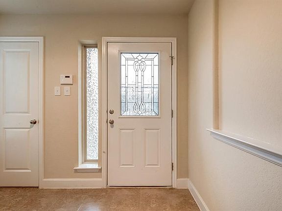 Upon walking in the home you are greeted with a leaded glass door and tile floors.