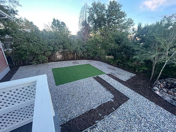 The backyard includes artificial turf to maintain a beautiful lawn year-round.