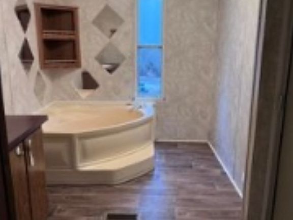 Master bathroom, toilet and shower to the right, sink to the left