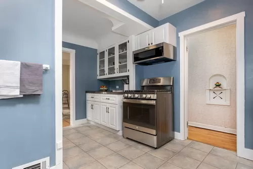 The updated kitchen with stainless steel appliances is equipped with everything you need from cookware to dishes - Utica St