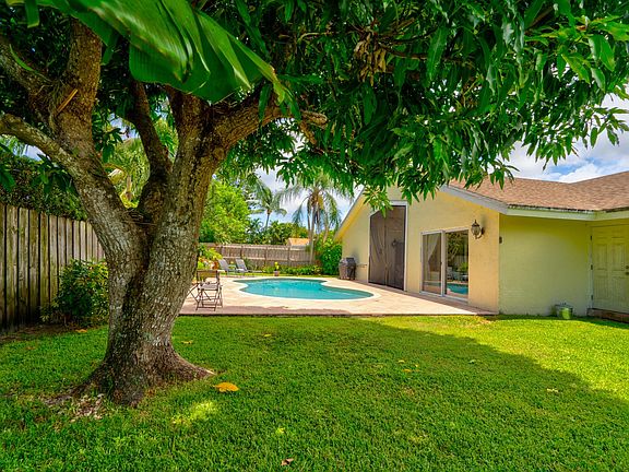 Mango tree, fenced yard for children or pets, salt water pool, pool gate/fence not pictured