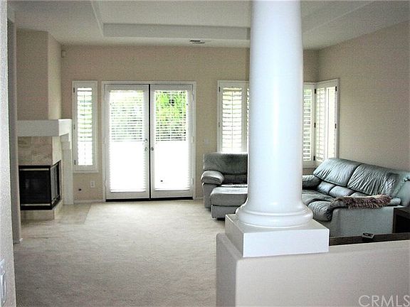 Living room as viewed as you walk in. French double doors lead to balcony. Balcony has golf course view.