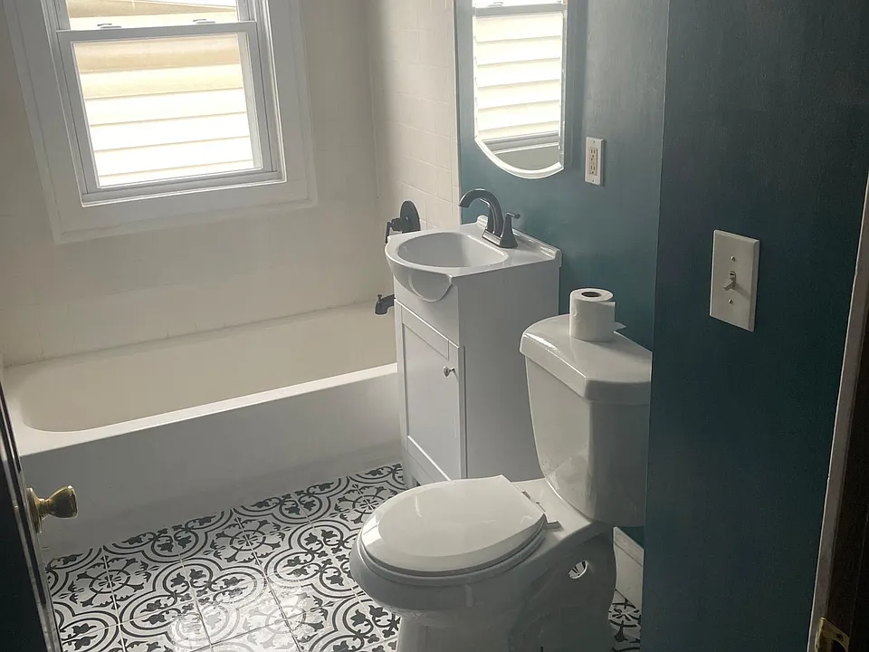 You will find true solace in this enchanting bathroom. Remodeled with Spanish tiles and fitted with Euro style appliances. The walls were painted a Deep Emerald.