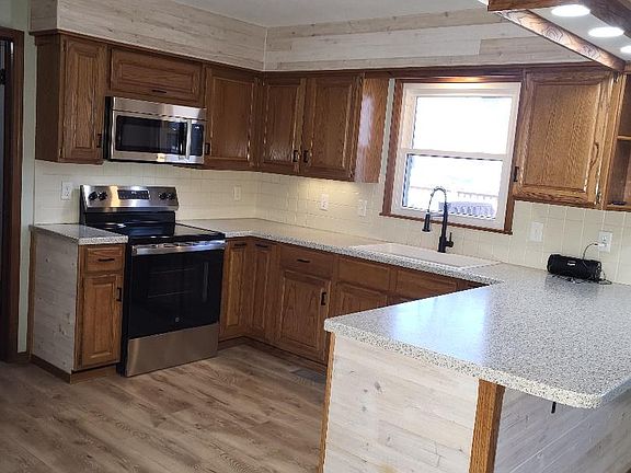 Open Kitchen with new appliances, solid surface countertops and new quartz sink, faucet and garbage disposal