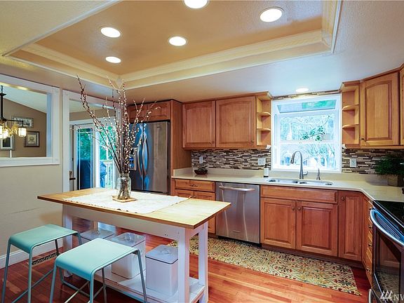 Light and bright kitchen with moveable island. Tastefully updated. All appliances remain!