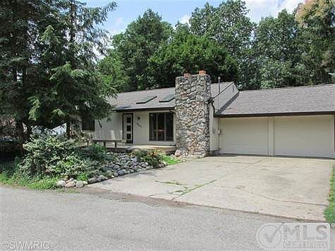 VIEW OF FRONT OF THE HOUSE WITH ATTACHED TWO CAR GARAGE AND FRONT ENTRY DECK