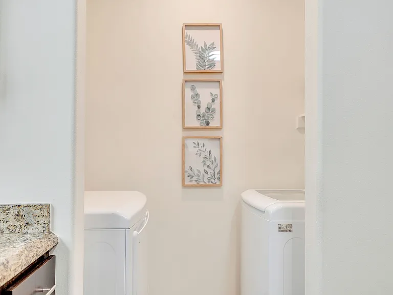 Elegant laundry room with sleek washer and dryer, showcasing the luxury of La Joya Apartments in Laredo, Texas