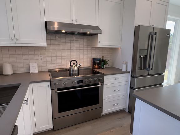 Kitchen features new stainless steel appliances, sleek countertops, and plenty of cabinet space.