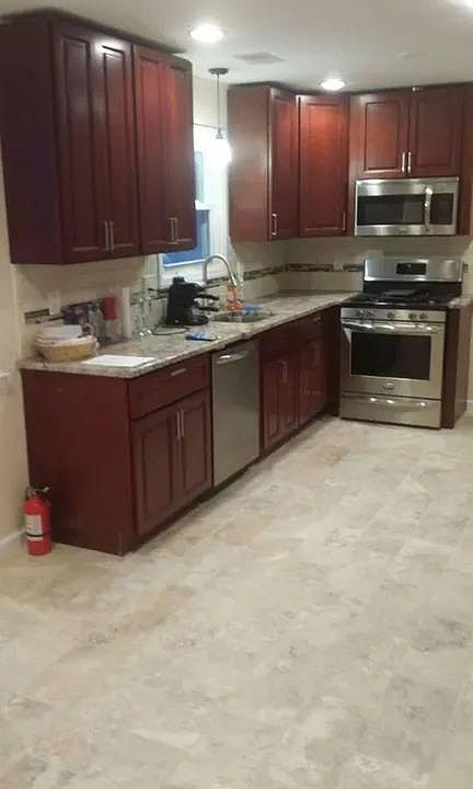 Kitchen Left side with Granite top and beautiful cherry color maple wood cabinets