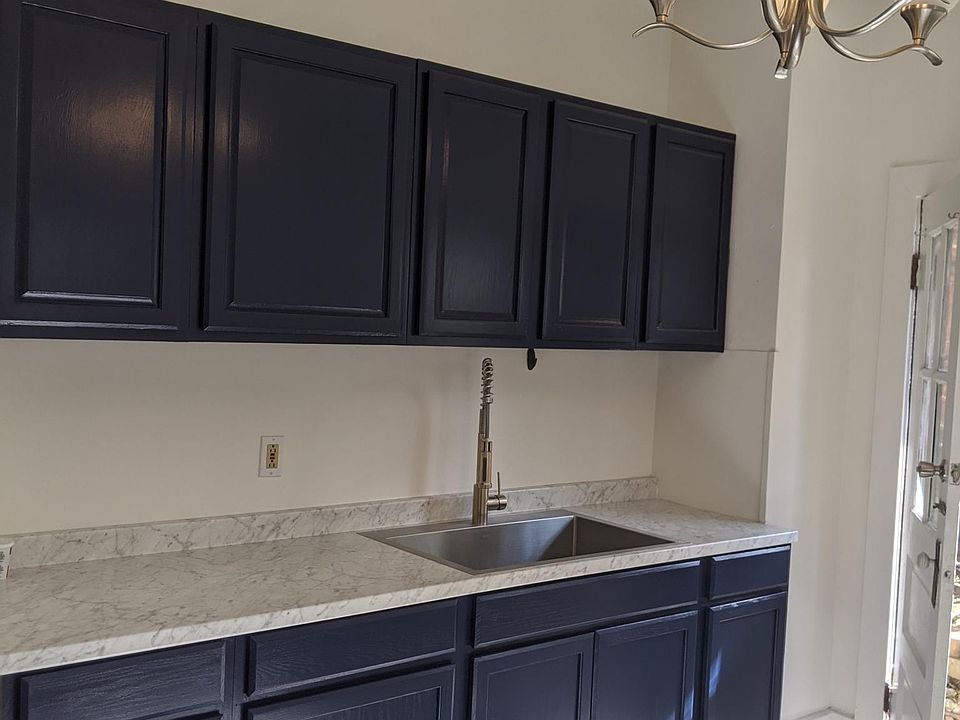 Brand new kitchen with tile floors, custom sink, and cabinetry. This photo is before the kitchen was finished with brushed nickel hardware and stainless appliances.