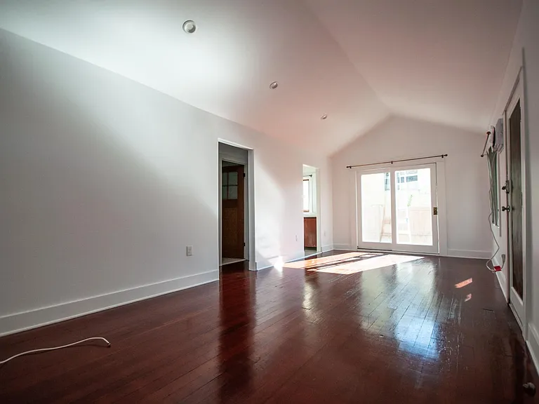 Doorway leads to kitchen, sliding doors to private side patio.