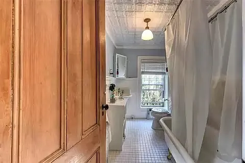 Bathroom with cast iron tub shower