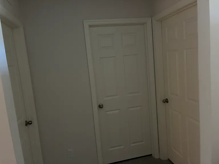 Bedroom number one located toward the front entrance of home followed by the main bathroom in the middle and bedroom number 2 (left hand side)