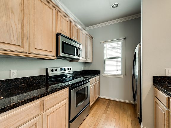 Kitchen with stainless steel appliances and granite counters