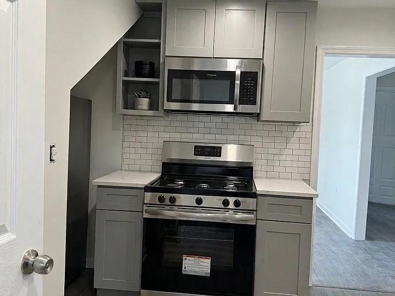 You'll enter the apartment in the kitchen, new fridge in the side nook.
