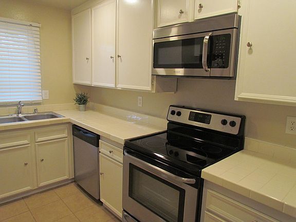 White kitchen with stainless steel appliances