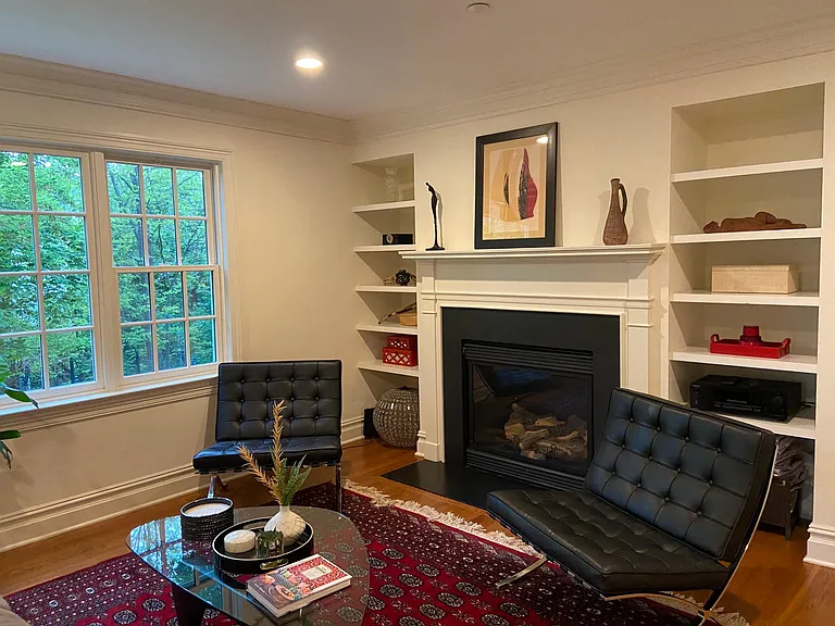Family room with gas fireplace. Windows look out to creek.