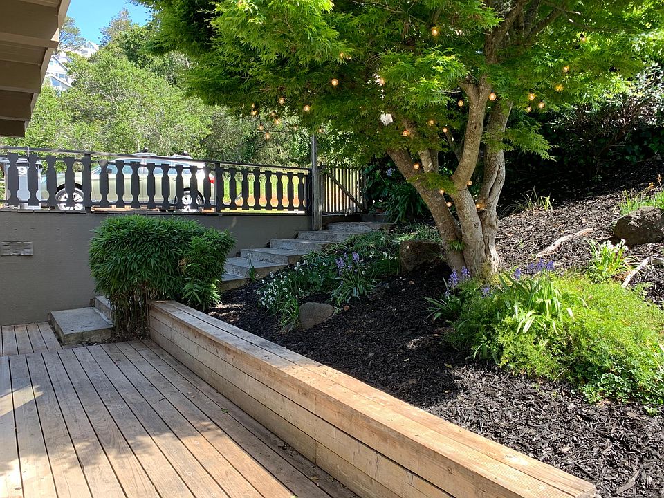 Front entry area. Charming garden area with deck for lounging or gardening