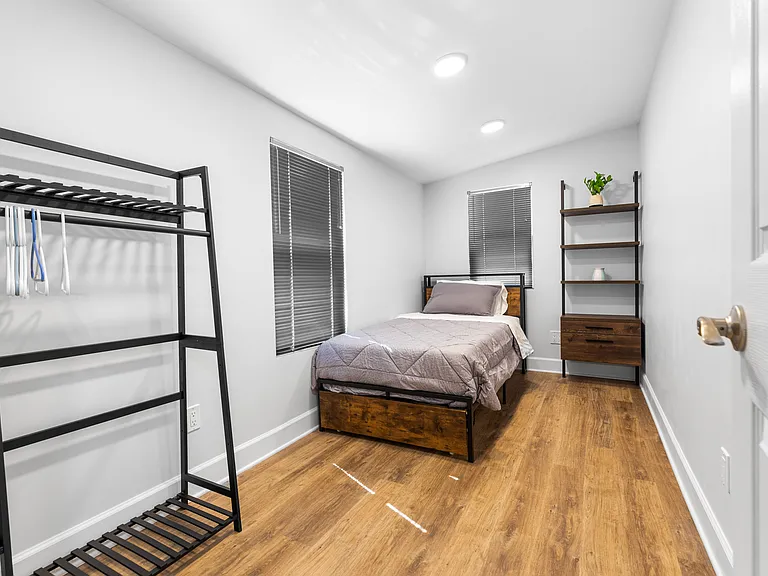 Front bedroom with a twin size bed close to the bathroom & main area.