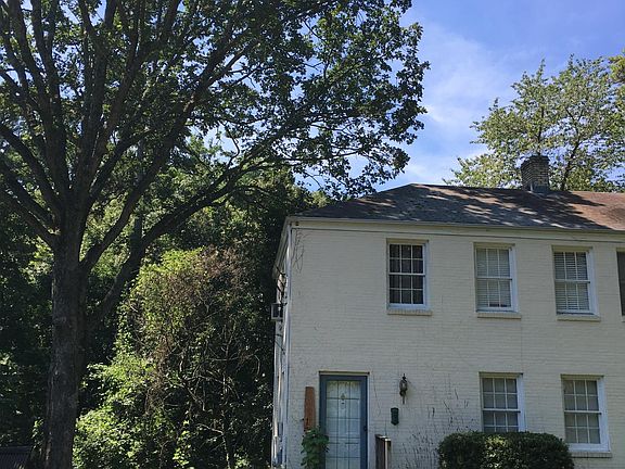 Charming home on a quiet street surrounded by mature towering trees.