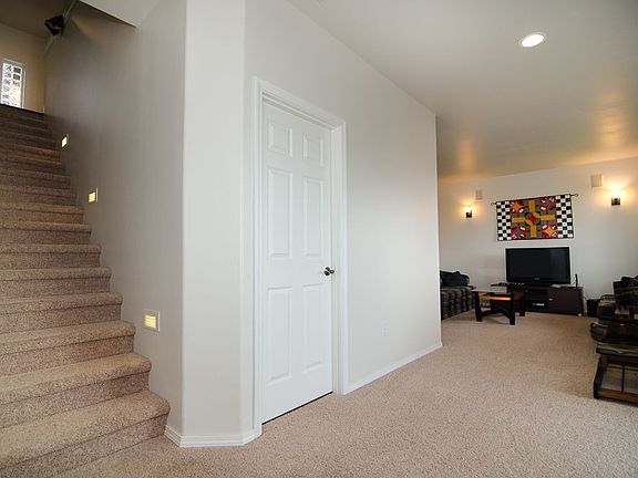 Sunny lower level features 3 bedrooms, a full bath, and a large, comfortable f
