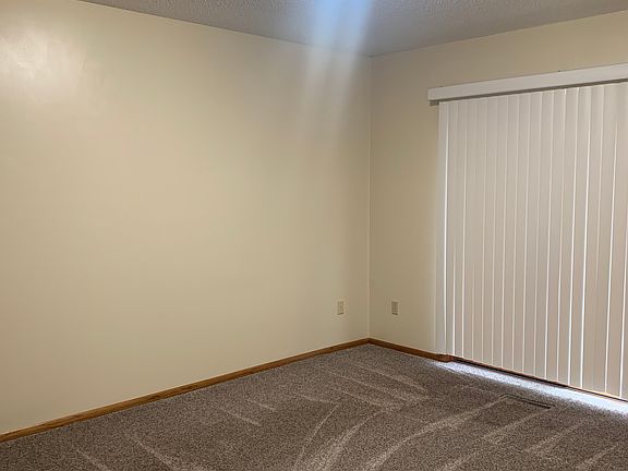 Master bedroom with full patio door and outdoor cement tpatio for enjoying your morning coffee.
