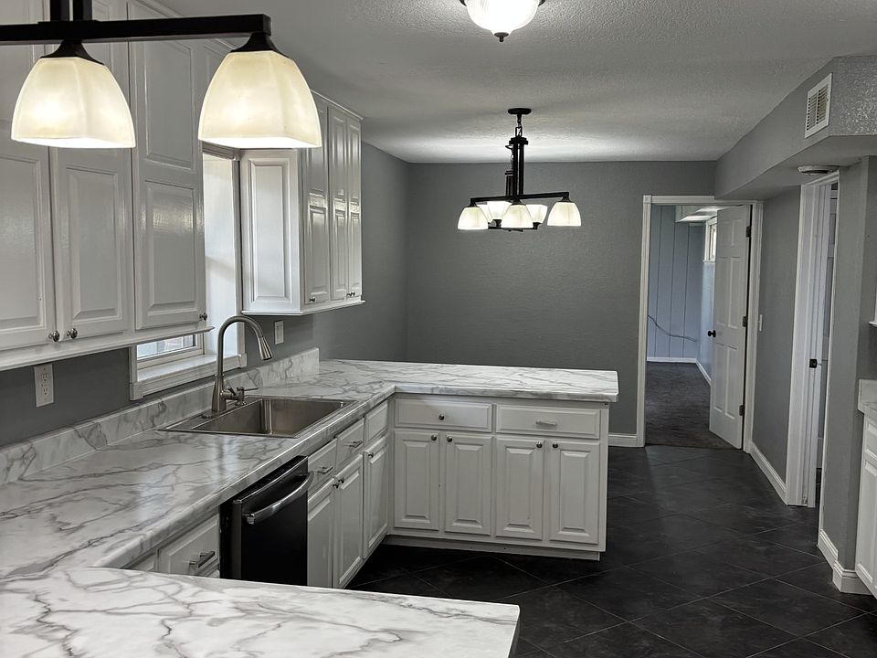Kitchen overlooking dining area with dishwasher, new wide sink, new countertops, and tall cabinets