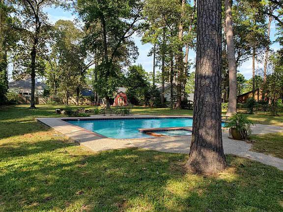 Spacious backyard with fire ring, pool, shed, and chicken coop.