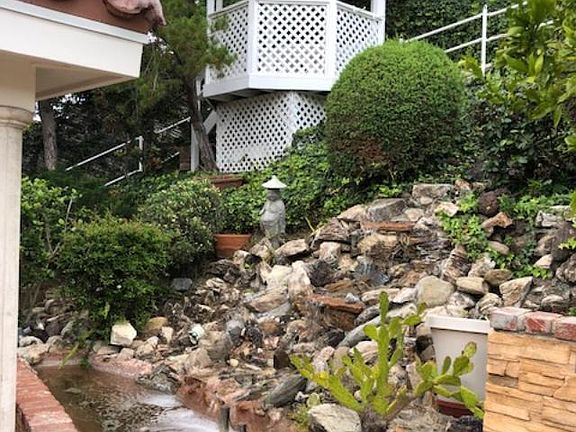 gazebo and pond with waterfall