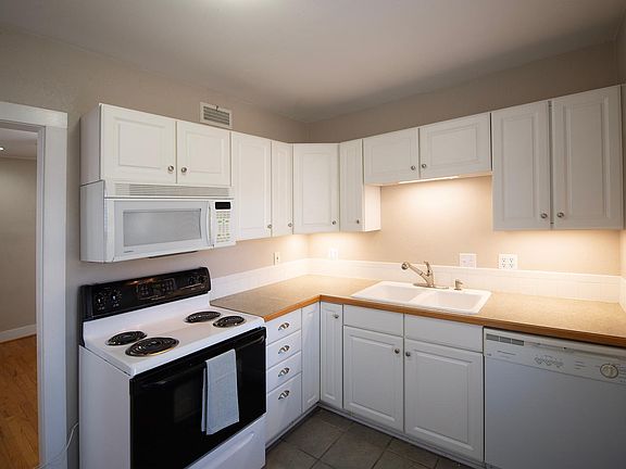 Kitchen with stove, dishwasher, garbage disposal, microwave and fridge