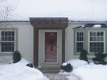 Pergola enhances the front door...note the bay window.
