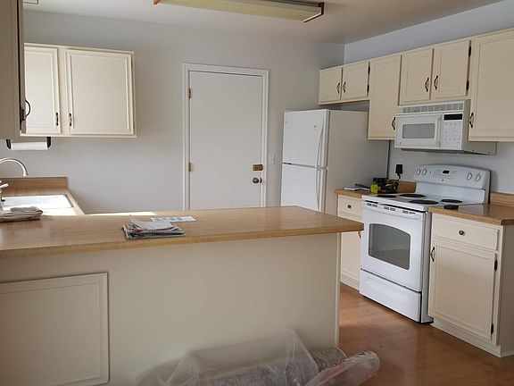 Kitchen, stove, and fridge.