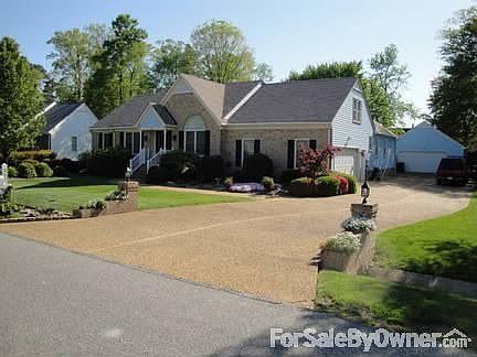 302 Allen Harris Drive
						:
						Front view capturing driveway and two garages