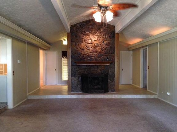 Great room with vaulted and large fireplace open to all
