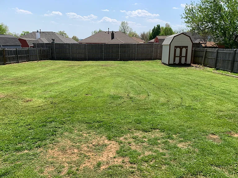 fenced backyard with storage shed