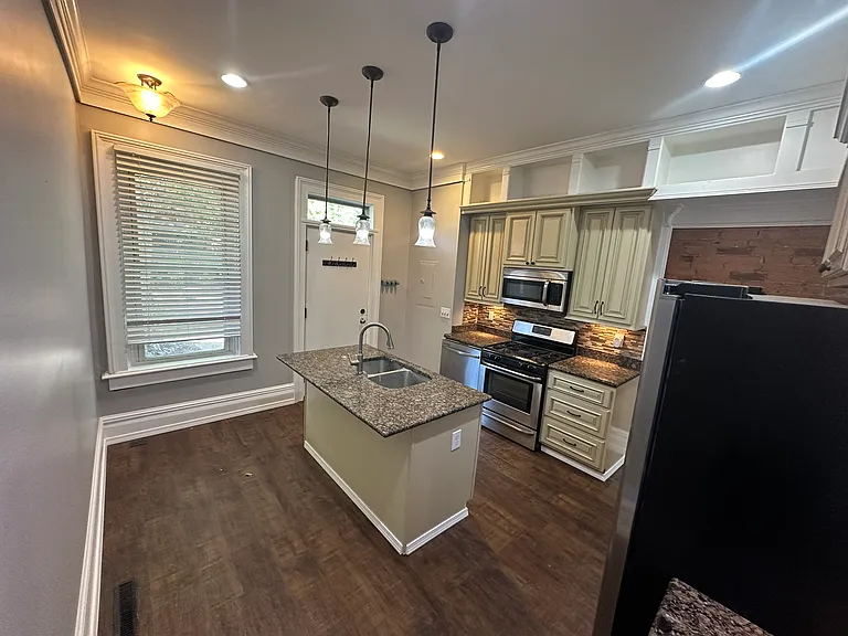 Kitchen with new floors, paint and updated appliances (stainless steel)