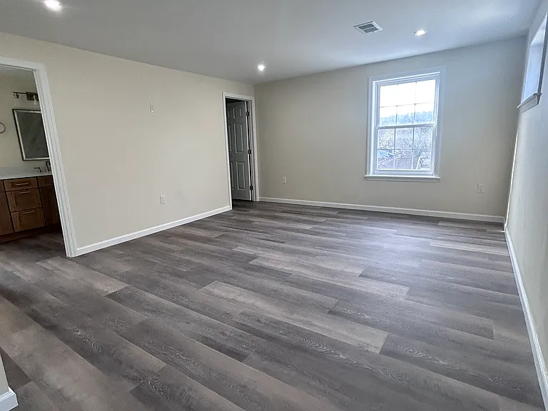 Primary Bedroom with view of WIC and En Suite Bathroom