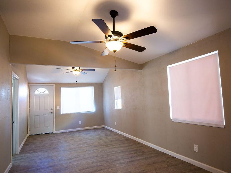Living room. Wood floors, ceiling fans, vaulted ceiling.