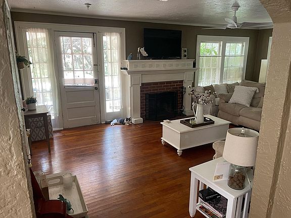 Living room. Fireplace decorative only. Door to screen porch on left of front door.