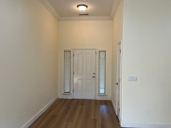 Front door and entry hall with coat closet.
