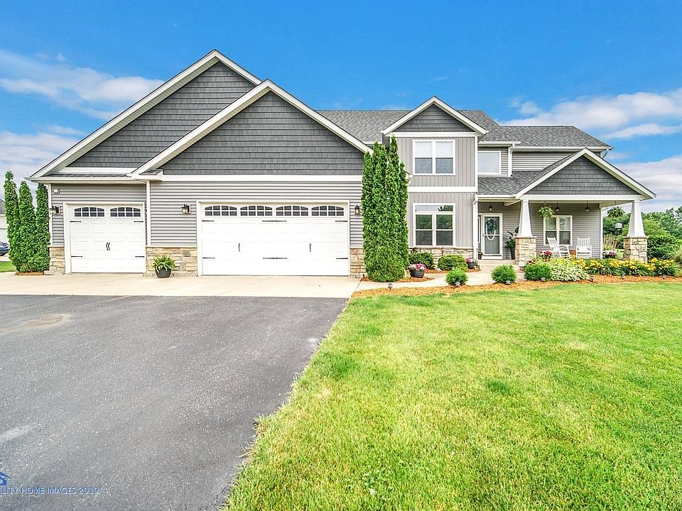 Recently remodeled exterior with Portfolio Greystone vinyl siding, Aspen White white trim, and Carbon accented shakes.