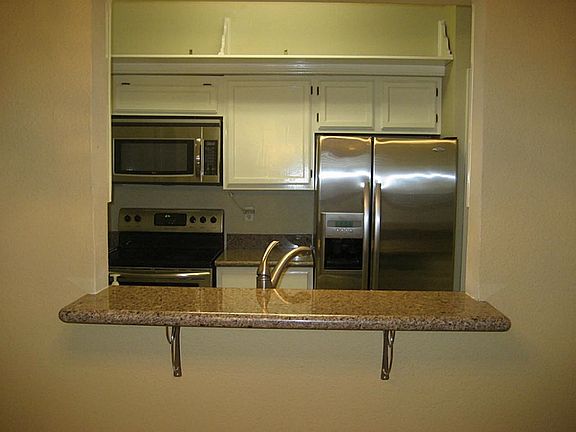 Kitchen has all stainless appliances. Refrigerator with wate