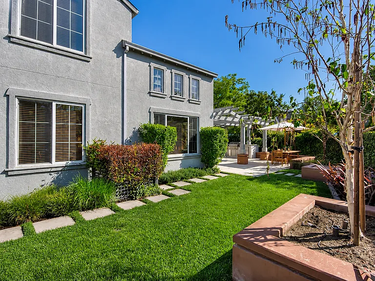 Beautifully landscaped backyard with expansive lawn.