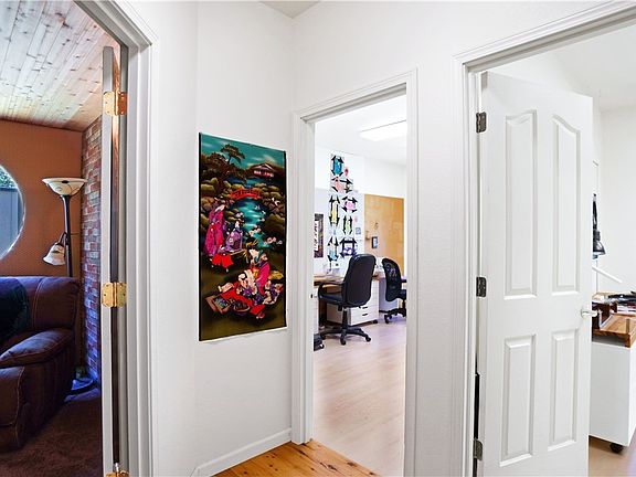 End of hallway with 2 bedrooms on the right and master suite entry on the left