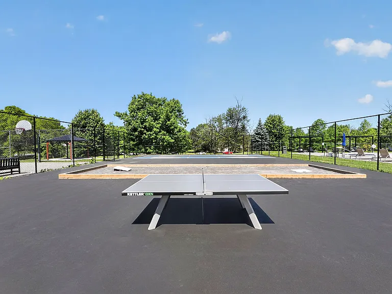 Join the fun at Lake Shore Park Apartments with our outdoor table tennis area, perfect for both relaxation and competition. Enjoy a spacious and inviting environment surrounded by green spaces. Make your move today!