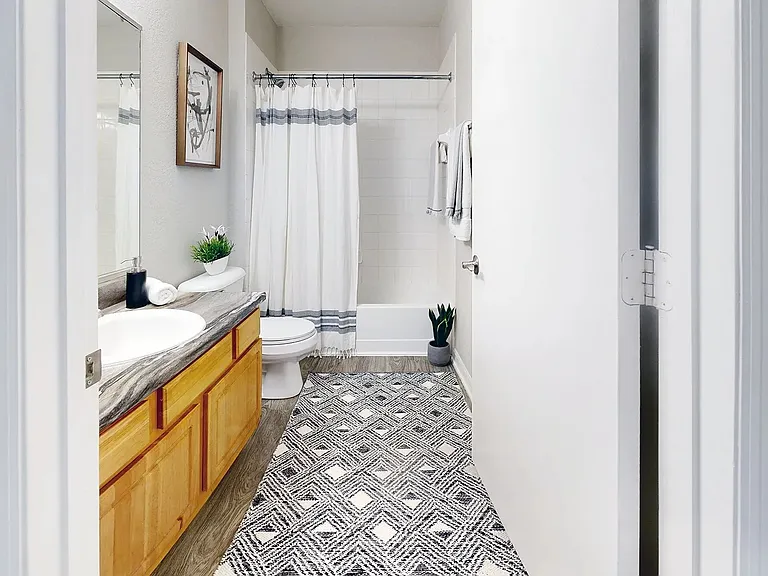 Serenity resides in the details of our signature bathroom at Eagle's Pointe. Immerse yourself in comfort and style with updated, refined finishes including wood-style flooring and black fusion countertops.