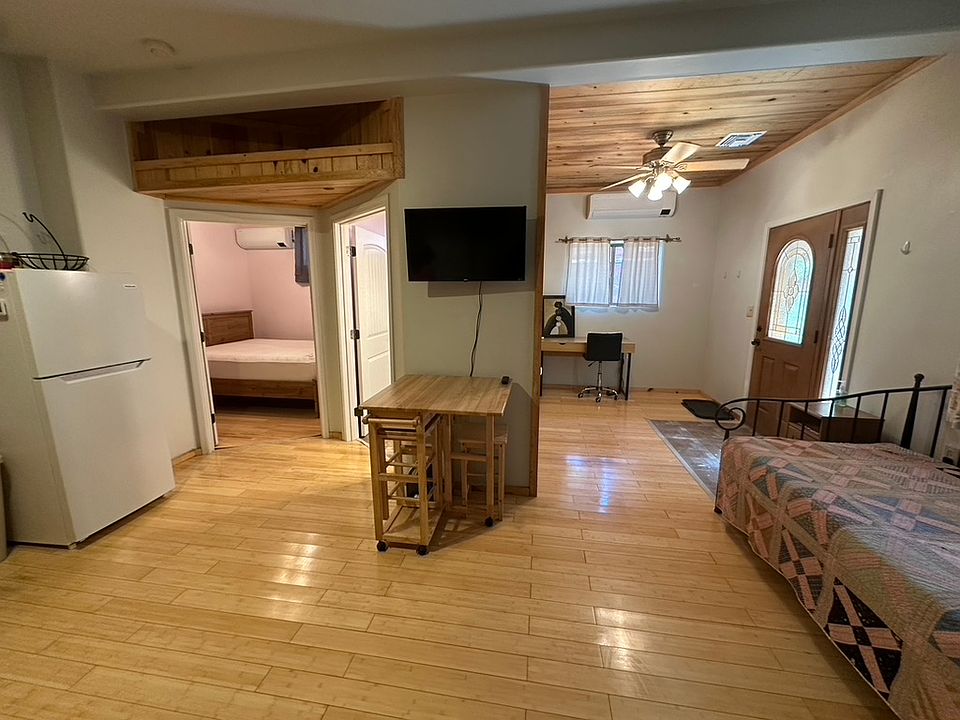 Reverse view. Fridge - bedroom - small dinette - office area - front door - extra trundle bed.