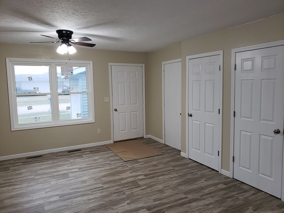 Living room with access door to garage, basement and entry closet