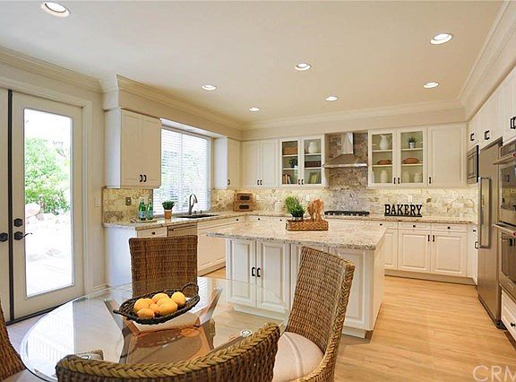 This is a shot of the kitchen from the nook showing the spacious professional kitchen with stainless