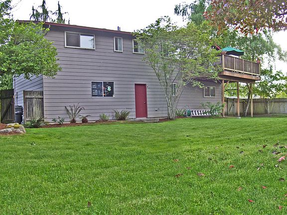 Back yard view of house with wood deck